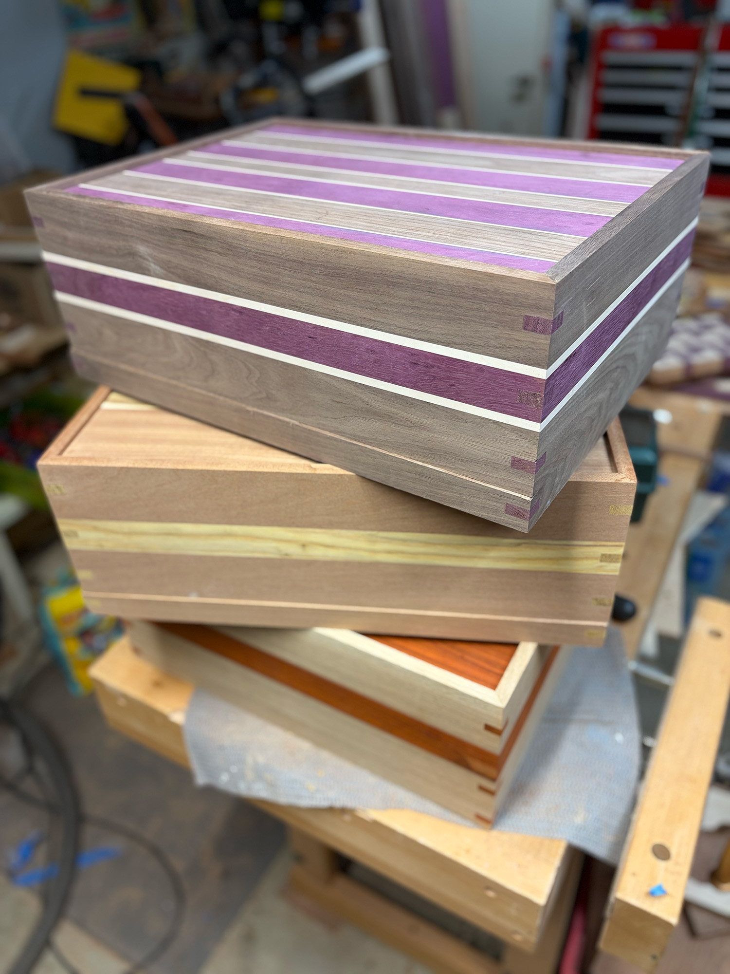 A stack of in-progress pedalboards in the shop